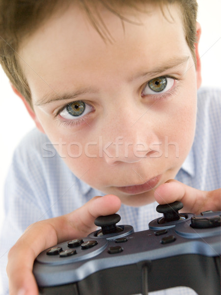 Young boy using videogame controller and concentrating Stock photo © monkey_business