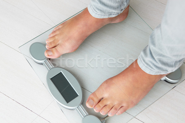 Stock photo: Close up detail girl weighing herself