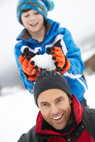 Young Boy About To Drop Snowball On Fathers Head Stock photo © monkey_business