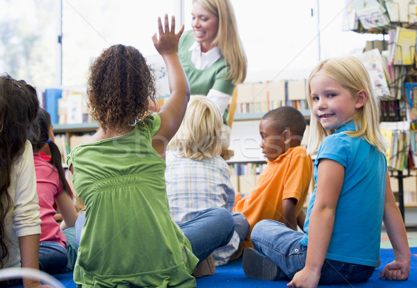 Kindergarten teacher reading to children in library, girl lookin Stock photo © monkey_business