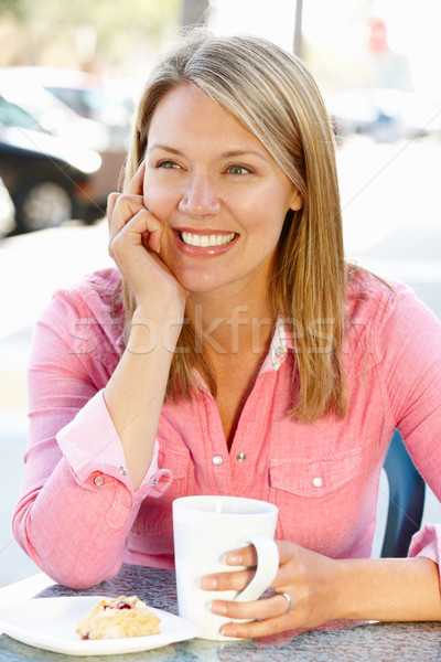 Woman sitting at sidewalk caf Stock photo © monkey_business