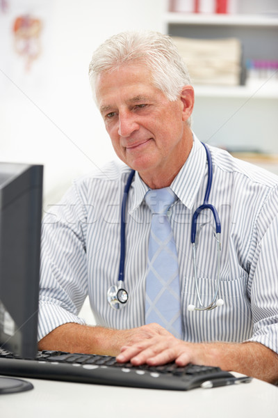 Senior doctor at desk Stock photo © monkey_business