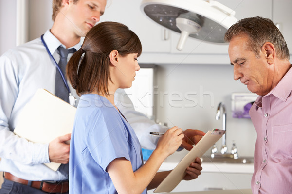 Male Patient Being Examined By Doctor And Intern Stock photo © monkey_business