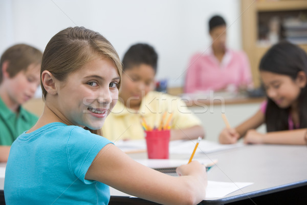 Elementary pupil in school classroom Stock photo © monkey_business