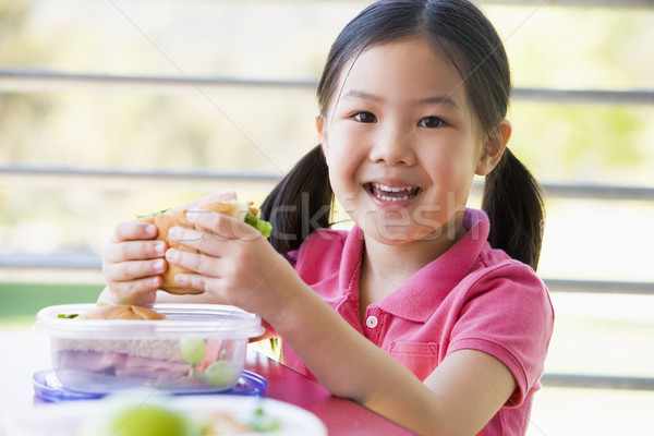 Stock photo: Girl eating lunch at kindergarten 