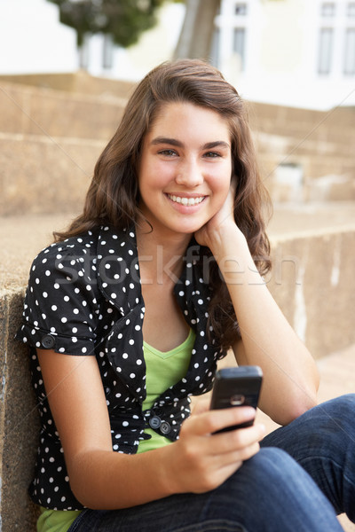 Teenage Student Sitting Outside On College Steps Using Mobile Ph Stock photo © monkey_business