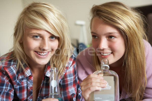 Two Teenage Girls Sitting On Sofa At Home Drinking Alcohol Stock photo © monkey_business
