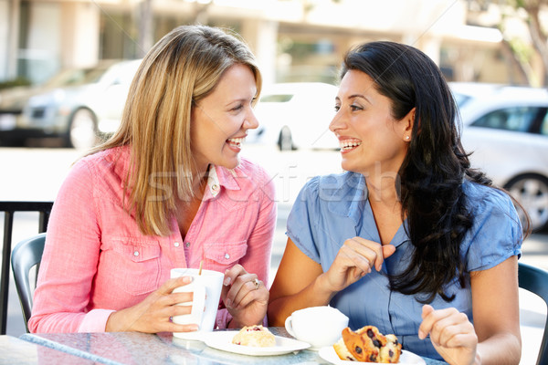 Women chatting over coffee and cakes Stock photo © monkey_business