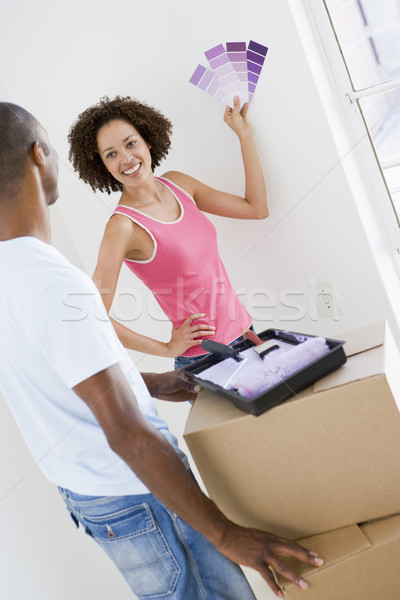 Stock photo: Couple with paint swatches in new home smiling