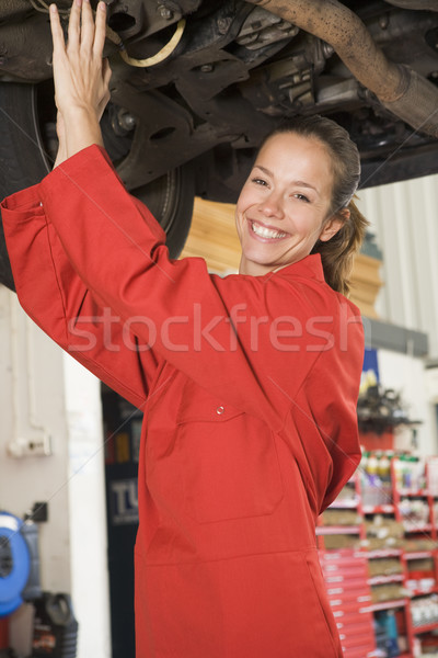 Stock photo: Mechanic working under car smiling