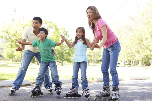 Family Putting On In Line Skates In Park Stock photo © monkey_business
