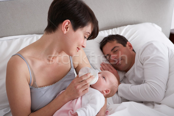 Mother Feeding Newborn Baby In Bed At Home Stock photo © monkey_business