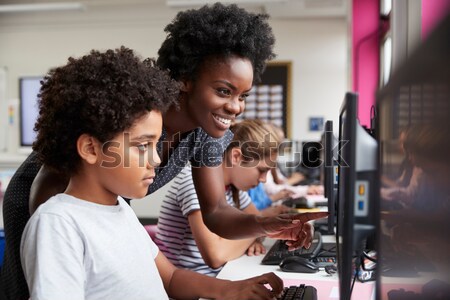 Professor ajuda estudantes trabalhando informática sala de aula Foto stock © monkey_business