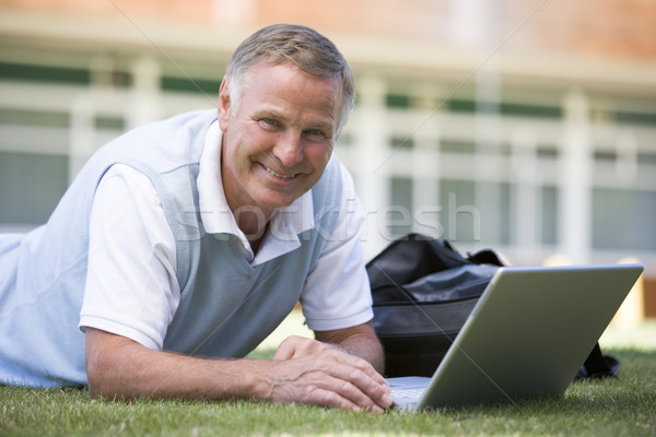 Om folosind laptop iarbă campus calculator student Imagine de stoc © monkey_business