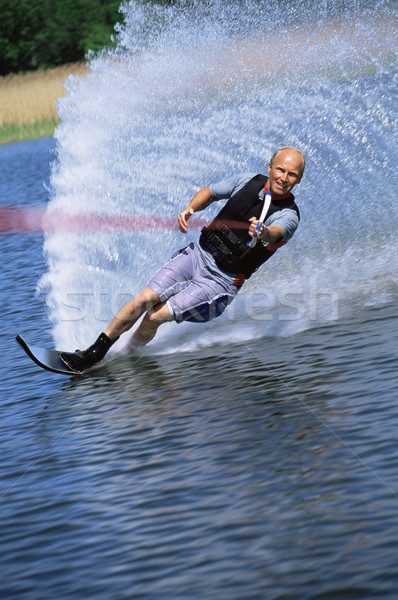 Stock photo: A young man water skiing