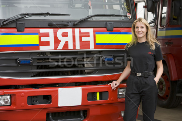 Portrait of a firefighter standing by a fire engine Stock photo © monkey_business