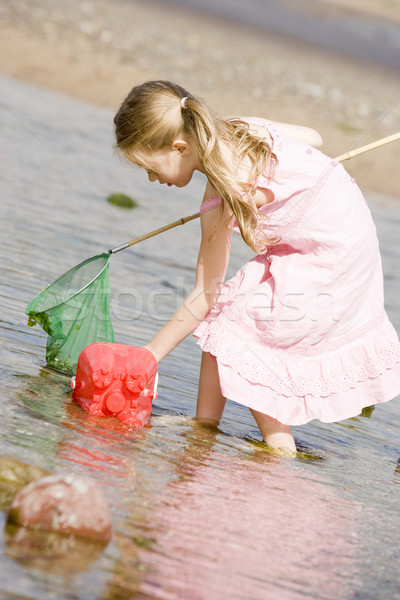 Young girl at beach with net and pail Stock photo © monkey_business