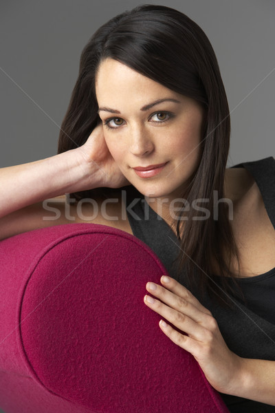 Studio Portrait Of Woman Relaxing On Pink Chaise Longue Stock photo © monkey_business