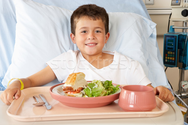 Fiú eszik étel kórházi ágy étel gyerekek Stock fotó © monkey_business