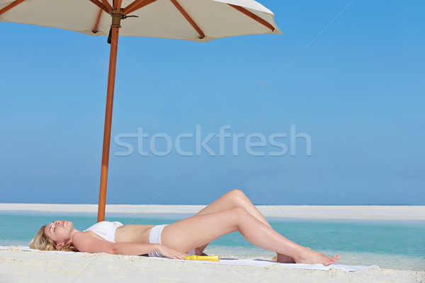 Woman Sunbathing On Beautiful Beach Holiday Stock photo © monkey_business