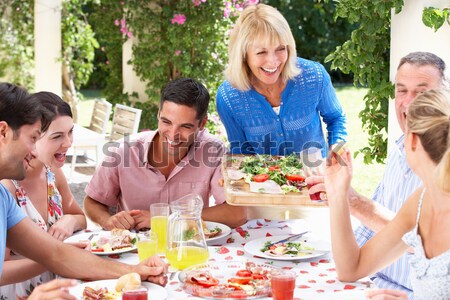Familie gratar femeie alimente om Imagine de stoc © monkey_business