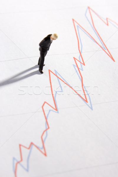 Figurine Of A Businessman Standing On A Line Graph Stock photo © monkey_business