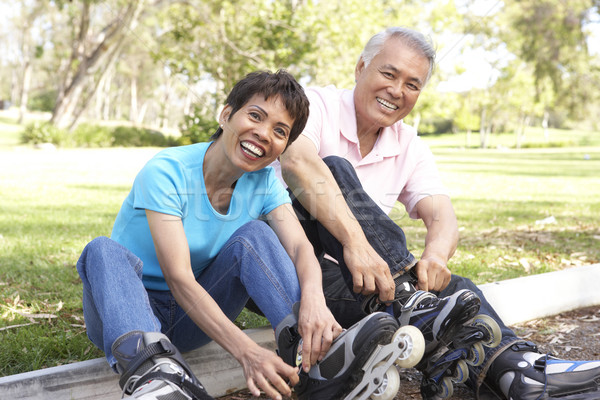 Senior Couple Putting On In Line Skates In Park Stock photo © monkey_business