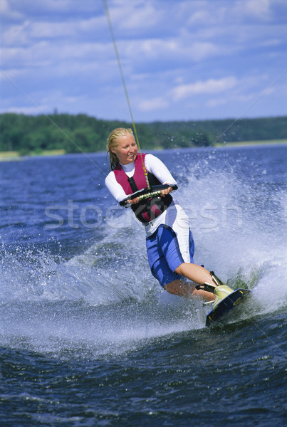 Stock photo: A young woman water skiing