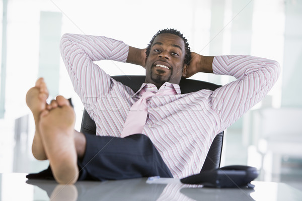 Stock photo: Businessman sitting in office with feet on desk relaxing and smi