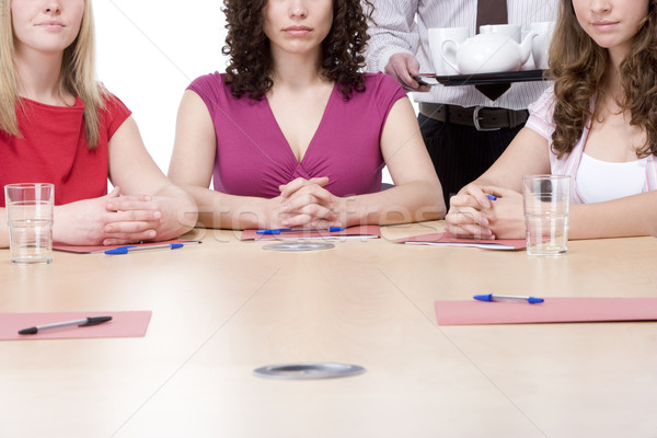Three businesswomen sitting in boardroom being served coffee and Stock photo © monkey_business