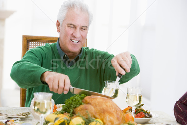 Stock photo: Man Carving Up Turkey At Christmas Dinner