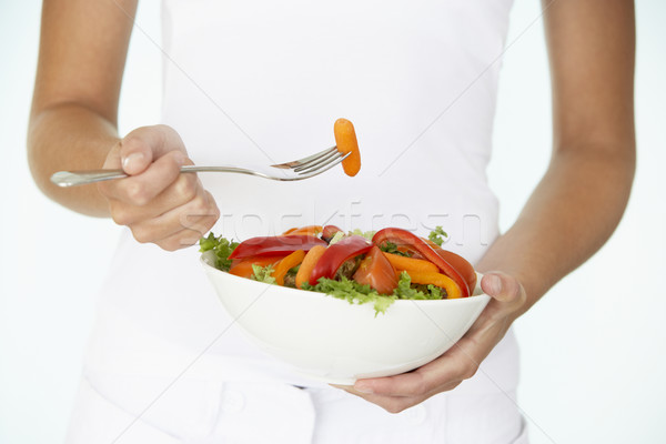 Fiatal nő tart tál saláta eszik sárgarépa Stock fotó © monkey_business