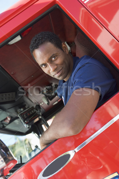 Bombeiro sessão táxi carro de bombeiros camisetas sorridente Foto stock © monkey_business