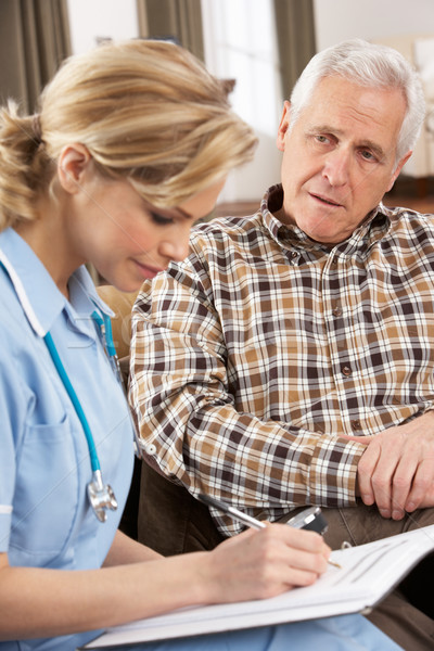 Stock photo: Senior Man Talking To Health Visitor At Home
