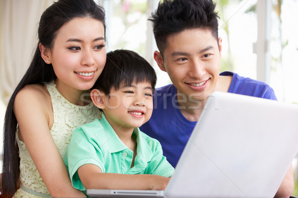 Chinese Family Sitting At Desk Using Laptop At Home Stock photo © monkey_business