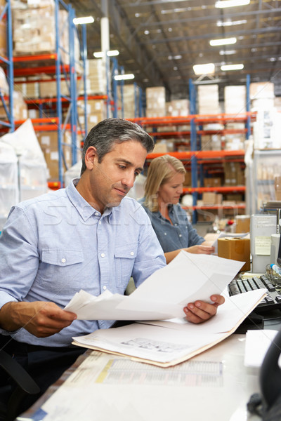 Business Colleagues Working At Desk In Warehouse Stock photo © monkey_business