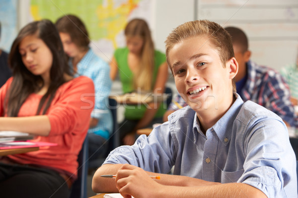 Portrait Of Male Pupil Studying At Desk In Classroom Stock photo © monkey_business