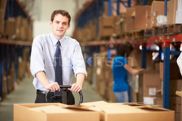 Businessman Pulling Pallet In Warehouse Stock photo © monkey_business