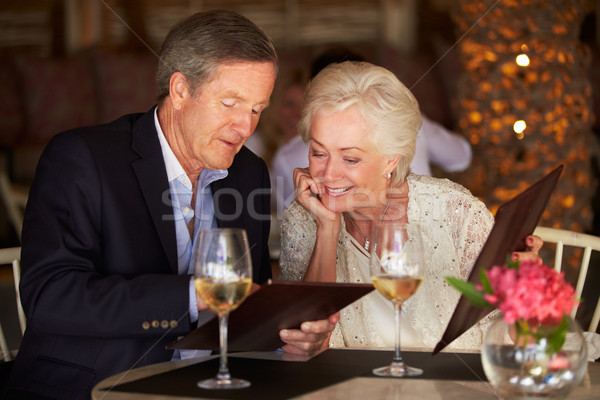 Senior Couple Choosing From Menu In Restaurant Stock photo © monkey_business