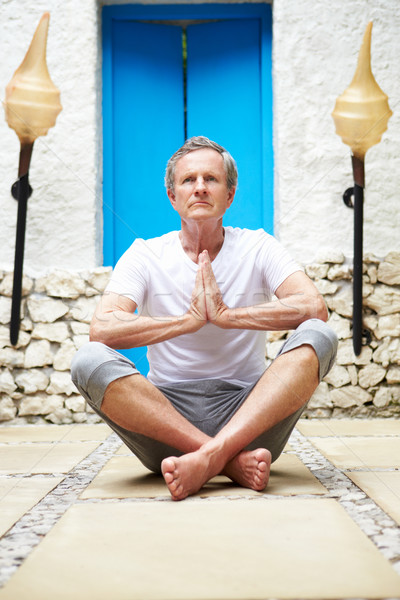 Senior Man Meditating Outdoors At Health Spa Stock photo © monkey_business