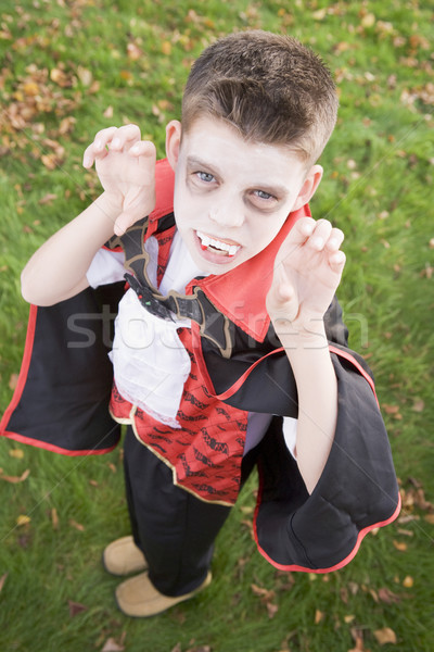 Young boy outdoors wearing vampire costume on Halloween Stock photo © monkey_business