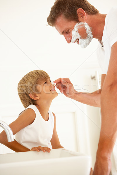 Stock photo: Son Watching Father Shaving In Bathroom Mirror
