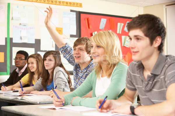 Teenage Students Studying In Classroom Answering Question Stock photo © monkey_business