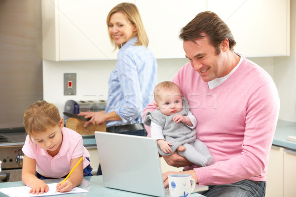 Family busy together in kitchen Stock photo © monkey_business