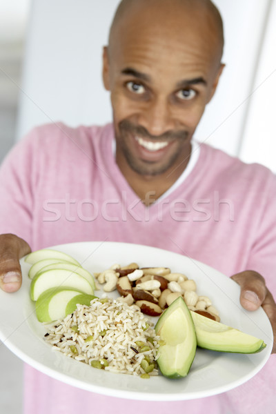 Middle Aged Man Holding Out A Plate With Healthy Foods Stock photo © monkey_business