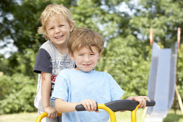 Stock photo: Two Young Boys Playing on Bike