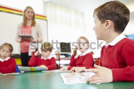 Female Teacher In Primary School Teaching Children To Tell Time  Stock photo © monkey_business