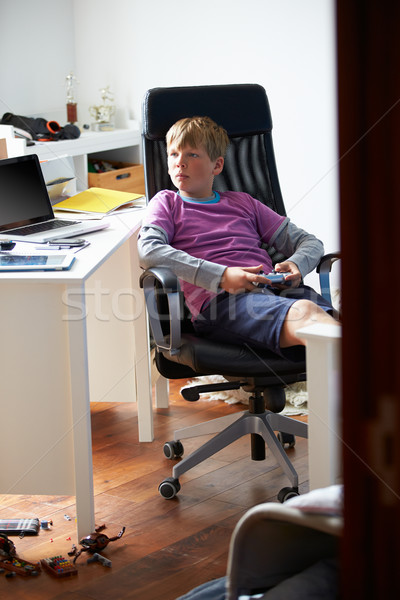 Boy Playing Video Game In Bedroom Stock photo © monkey_business