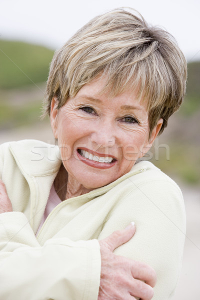 Woman at the beach cold and smiling Stock photo © monkey_business