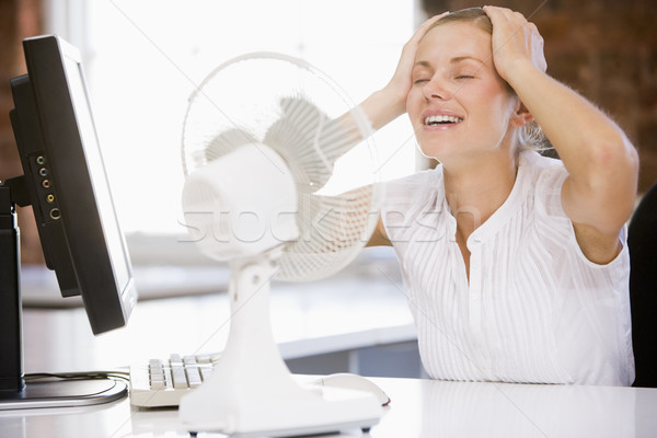 Businesswoman in office with computer and fan cooling off Stock photo © monkey_business